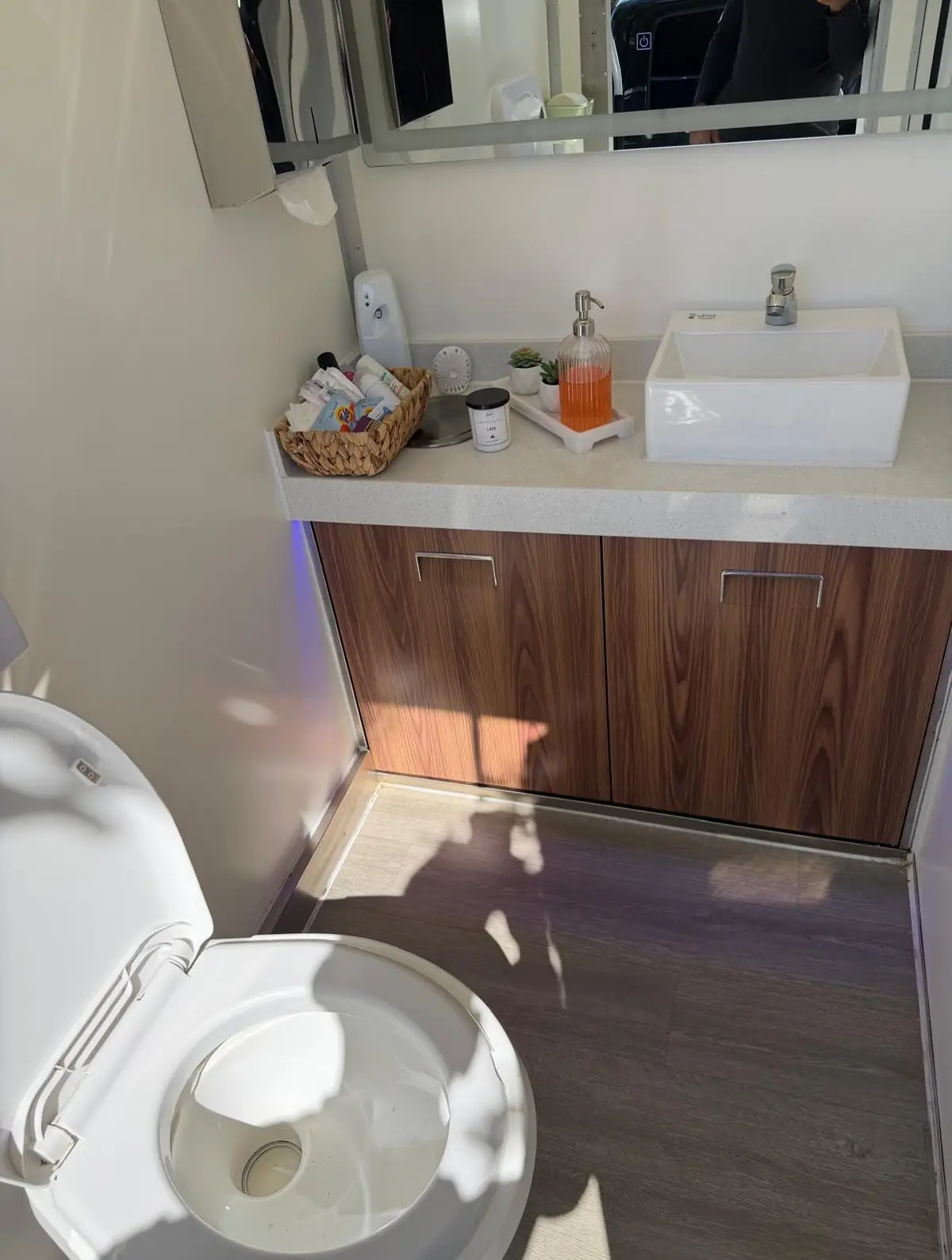 Vanity counter with vessel sink and soap inside a restroom trailer