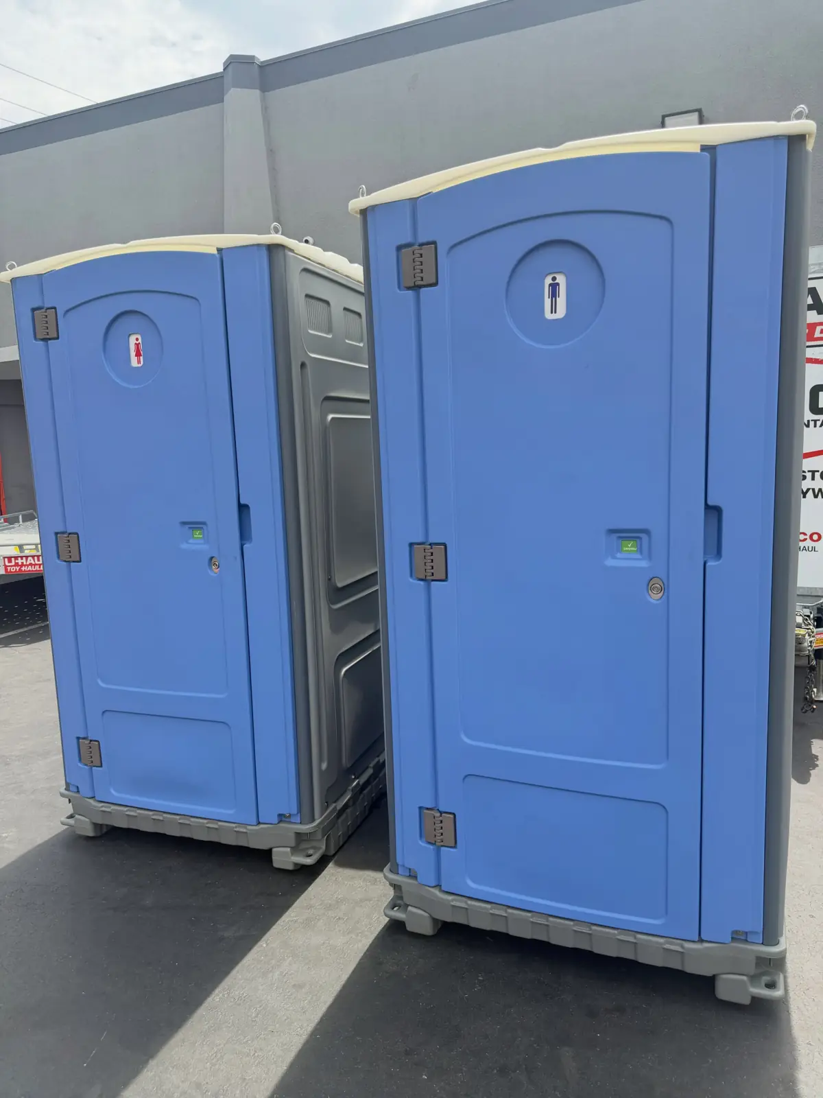 Two blue portable toilets ready to load for delivery